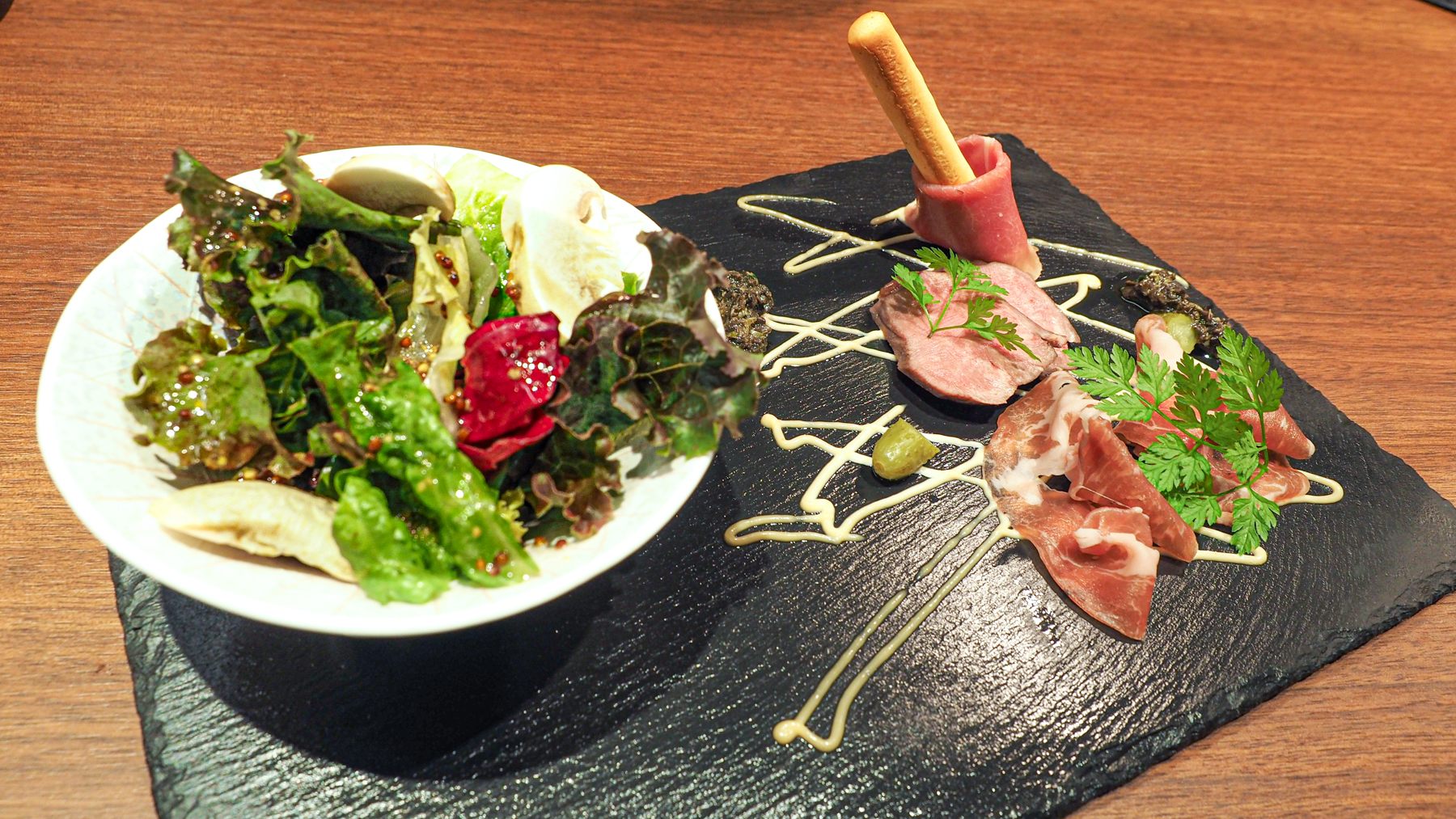 Salad with fresh mashroom and assorted cured ham as appetizer of Kaiseki Cuisine MIYABI with BBQ