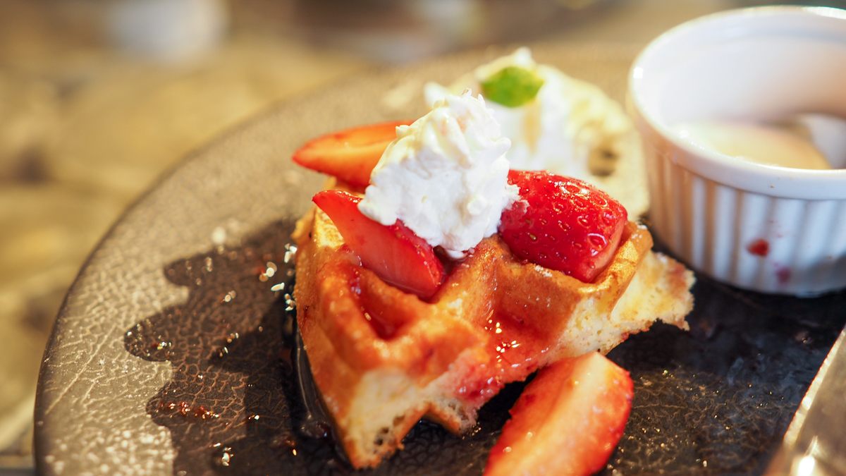 Waffle topped with cream and strawberry
