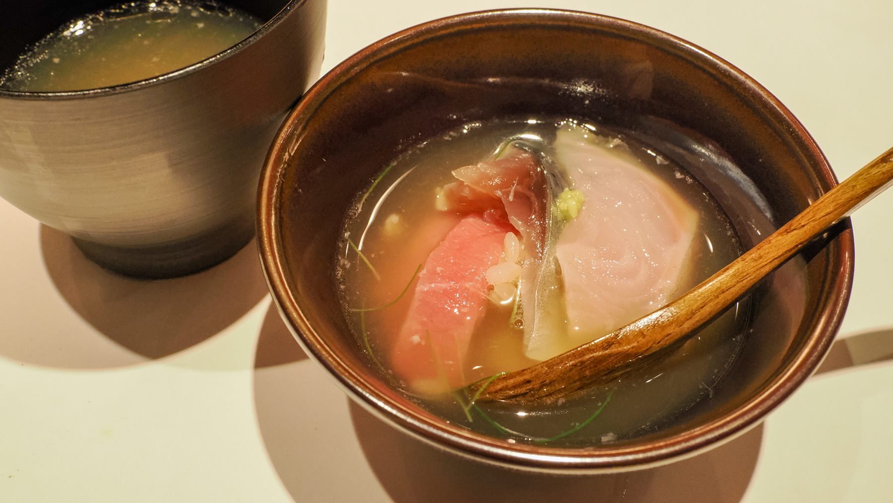 The bowl of rice topped with sashimi and fish broth in "ochazuke" style