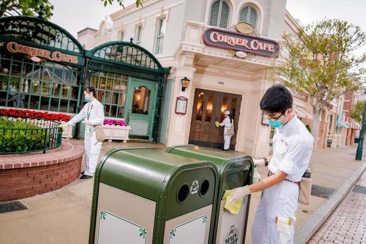 Cast Members clean park area during day time.jpeg