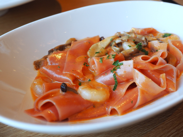 Beet-pappardelle with shrimp and mushroom served with tomato cream sauce